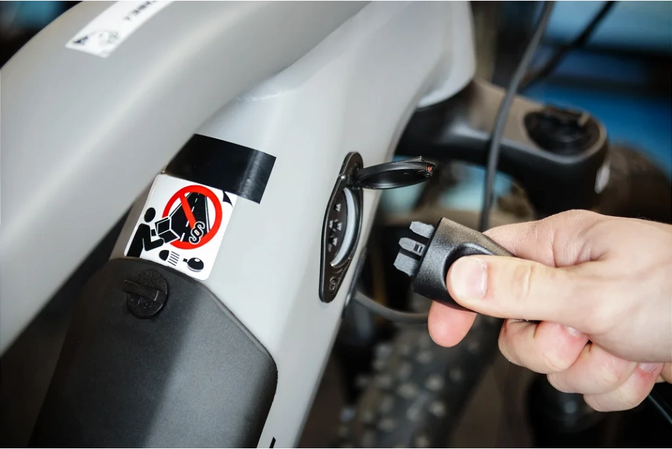 Technician replacing battery in eBike for reliable performance