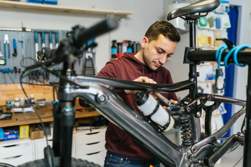 Technician expertly assembling an electric bike, ensuring secure electrical connections, customized fitting, and comprehensive safety checks for optimal performance