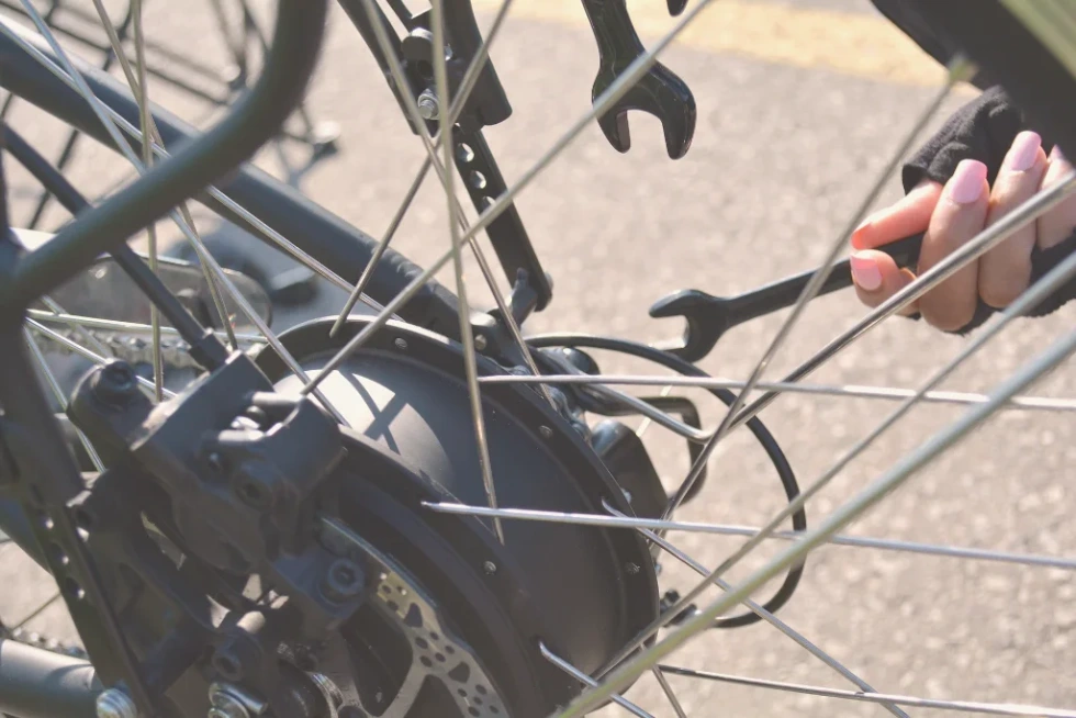 Technician adjusting brakes on an eBike for enhanced safety and performance