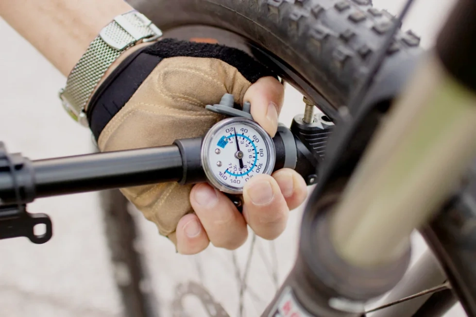 Technician repairing a flat tire on an eBike, inspecting for punctures, replacing tubes, and checking tire pressure for a safe and smooth ride