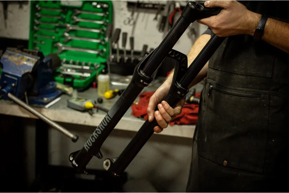 Technician adjusting the suspension system of an eBike to improve ride quality and comfort